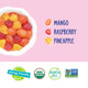 A bowl of YumEarth Tropical Fruit Snacks with the flavors on the right and the reasons to believe in the candy below