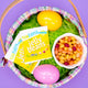 Easter basket with YumEarth jelly beans pack and colorful eggs on a purple background, labeled allergy‑friendly and free from artificial dyes.