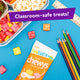 Flat lay of YumEarth Fruit Snacks pouch next to a school lunch and colorful pencils