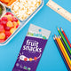 Lunch tray with YumEarth Chewys pack, colorful pencils, and text reading “Classroom-safe treats!”