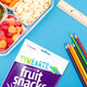 Close-up of YumEarth Fruit Snacks next to a school lunch tray with ruler and pencils